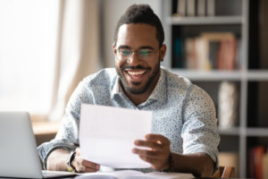 happy man looking at paperwork
